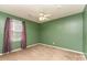 Simple bedroom with green walls, carpet flooring, and a ceiling fan for added comfort at 6769 Highway 557 None, Clover, SC 29710