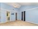 Bright bedroom with a vaulted ceiling, blue walls, a ceiling fan, and access to the bathroom at 6769 Highway 557 None, Clover, SC 29710