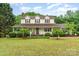 Inviting two-story home with a covered porch, lush landscaping, and a well-maintained lawn at 6769 Highway 557 None, Clover, SC 29710