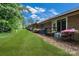 Backyard view featuring a well-maintained lawn, brick facade, and access to outdoor space at 704 Colby Cir, Salisbury, NC 28147