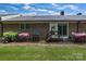 Rear exterior showcasing a well-kept yard, back patio, and brick facade at 704 Colby Cir, Salisbury, NC 28147