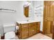 Bathroom featuring a vanity with wood cabinetry, sink, toilet, and towel racks at 704 Colby Cir, Salisbury, NC 28147