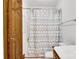 Bathroom with a shower featuring a patterned curtain, toilet, and wood door at 704 Colby Cir, Salisbury, NC 28147