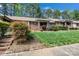 Inviting brick home with beautiful landscaping, green lawn, and walkway leading to the entrance at 704 Colby Cir, Salisbury, NC 28147