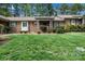 Charming brick home with lush green lawn, mature trees, and inviting front entrance at 704 Colby Cir, Salisbury, NC 28147