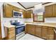 Functional kitchen with wood cabinetry, stainless steel range, and double basin sink at 704 Colby Cir, Salisbury, NC 28147