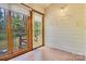 Cozy sunroom with large windows and door offering views of the outdoor deck and wooded area at 704 Colby Cir, Salisbury, NC 28147
