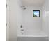 Clean white bathroom with a tub and shower, featuring subway tile and modern fixtures at 721 Charles Ave, Charlotte, NC 28205