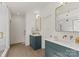 This bathroom offers blue vanities, gold fixtures, and bright lighting at 721 Charles Ave, Charlotte, NC 28205