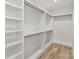Walk-in closet features custom shelving and hardwood floors at 721 Charles Ave, Charlotte, NC 28205