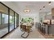 Bright dining area open to living room and kitchen, with view to covered patio through sliding glass doors at 721 Charles Ave, Charlotte, NC 28205
