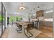 Open-concept dining area with a unique light fixture, seamlessly connected to the kitchen and living room at 721 Charles Ave, Charlotte, NC 28205
