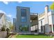 Contemporary home with a sleek gray exterior, multiple balconies, and well-manicured landscaping at 721 Charles Ave, Charlotte, NC 28205