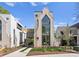 Striking modern home with architectural details, a three-story window feature, and manicured landscaping at 721 Charles Ave, Charlotte, NC 28205