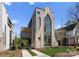 Stunning modern home with architectural detail, three-story window feature, and inviting driveway at 721 Charles Ave, Charlotte, NC 28205