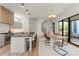Modern kitchen with a large island, seating, wood accents, and stainless steel appliances at 721 Charles Ave, Charlotte, NC 28205