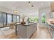 Spacious open kitchen featuring a large island, modern appliances, and seamless connection to dining and living areas at 721 Charles Ave, Charlotte, NC 28205