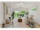 Bright living room with fireplace, large windows, and natural light overlooking backyard greenery at 721 Charles Ave, Charlotte, NC 28205
