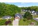 An aerial shot showcases the home's landscaping, large yard, and position in a tranquil residential community at 7239 Oxford Hunt Dr, Stanley, NC 28164