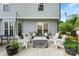 Well-appointed backyard patio with a fire pit, string lights, and comfortable seating arrangement at 7239 Oxford Hunt Dr, Stanley, NC 28164