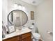 Powder bathroom with white vanity, designer mirror, and decorative lighting at 7239 Oxford Hunt Dr, Stanley, NC 28164