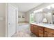Bathroom boasts dual sink vanity, soaking tub, and neutral finishes at 7239 Oxford Hunt Dr, Stanley, NC 28164