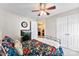 This bedroom features floral bedding and a ceiling fan at 7239 Oxford Hunt Dr, Stanley, NC 28164