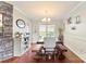 Elegant dining area features a chandelier, table with bench seating, and a window that overlooks the backyard at 7239 Oxford Hunt Dr, Stanley, NC 28164