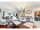 Open dining room features hardwood floors, vaulted ceiling, and designer lighting fixture and opens to the living room at 7239 Oxford Hunt Dr, Stanley, NC 28164