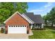 Charming brick home featuring a two-car garage and landscaped front yard in a beautiful residential neighborhood at 7239 Oxford Hunt Dr, Stanley, NC 28164