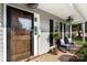 Inviting front porch features a glass front door, stylish lighting, and comfortable seating for relaxing outdoors at 7239 Oxford Hunt Dr, Stanley, NC 28164