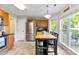 Eat-in kitchen features stainless steel appliances, tile floors, and a large window overlooking the backyard at 7239 Oxford Hunt Dr, Stanley, NC 28164