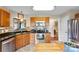 Kitchen featuring stainless steel appliances, wood cabinetry, granite countertops, and tile backsplash at 7239 Oxford Hunt Dr, Stanley, NC 28164