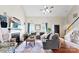 Bright living room boasts hardwood floors, a cozy fireplace, and a comfortable sectional couch perfect for Gathering gatherings at 7239 Oxford Hunt Dr, Stanley, NC 28164