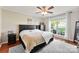 Bright main bedroom features a ceiling fan, a large window, and hardwood floors at 7239 Oxford Hunt Dr, Stanley, NC 28164