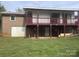 Two-story home featuring a covered deck with stairs leading to the yard at 7527 Old Shelby Rd, Vale, NC 28168