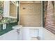 Small bathroom with sink, toilet, brick accent wall, and green wall art at 7527 Old Shelby Rd, Vale, NC 28168