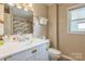 Bathroom featuring a marble countertop, with a matching framed mirror and shower at 7527 Old Shelby Rd, Vale, NC 28168