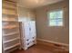 Bedroom with hardwood floors and large white wardrobe at 7527 Old Shelby Rd, Vale, NC 28168