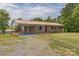 Charming single-story brick home with a metal roof, covered carport, and well-maintained front yard at 7527 Old Shelby Rd, Vale, NC 28168