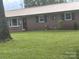 Charming single-story brick home with well-maintained front lawn and metal roof at 7527 Old Shelby Rd, Vale, NC 28168