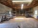 Spacious garage or workshop with shelving and wooden beam ceiling at 7527 Old Shelby Rd, Vale, NC 28168