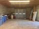 Spacious unfinished garage with rolling door and ample storage space at 7527 Old Shelby Rd, Vale, NC 28168