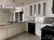 A kitchen with white cabinets, stainless steel backsplash, and a double sink at 7527 Old Shelby Rd, Vale, NC 28168