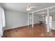 Open-concept living area with hardwood floors, natural light, and view into kitchen and dining at 7527 Old Shelby Rd, Vale, NC 28168