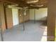 Covered back patio with concrete floor and brick wall at 7527 Old Shelby Rd, Vale, NC 28168