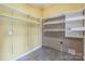 A yellow storage room with laminate floors and shelves for storage at 7527 Old Shelby Rd, Vale, NC 28168