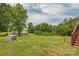 Spacious yard with lush green grass, fencing and mature trees at 7527 Old Shelby Rd, Vale, NC 28168