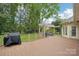 Backyard featuring a large deck, a grill, an outdoor dining set, and a well-manicured lawn at 7626 Vistaview Dr, Cornelius, NC 28031