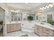 Bright bathroom featuring a large jacuzzi tub with tile surround, dual sinks, and large mirrors at 7626 Vistaview Dr, Cornelius, NC 28031